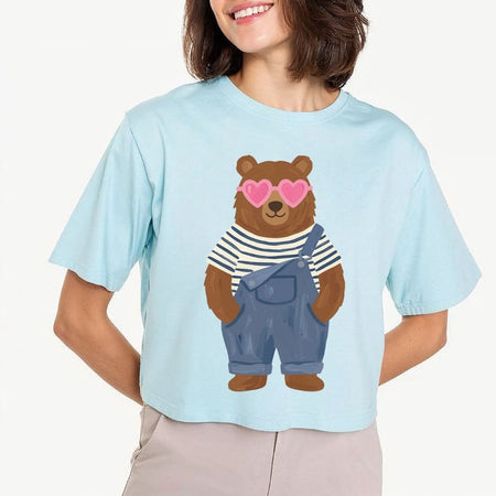 Person wearing a light blue t-shirt with a bear graphic design.
