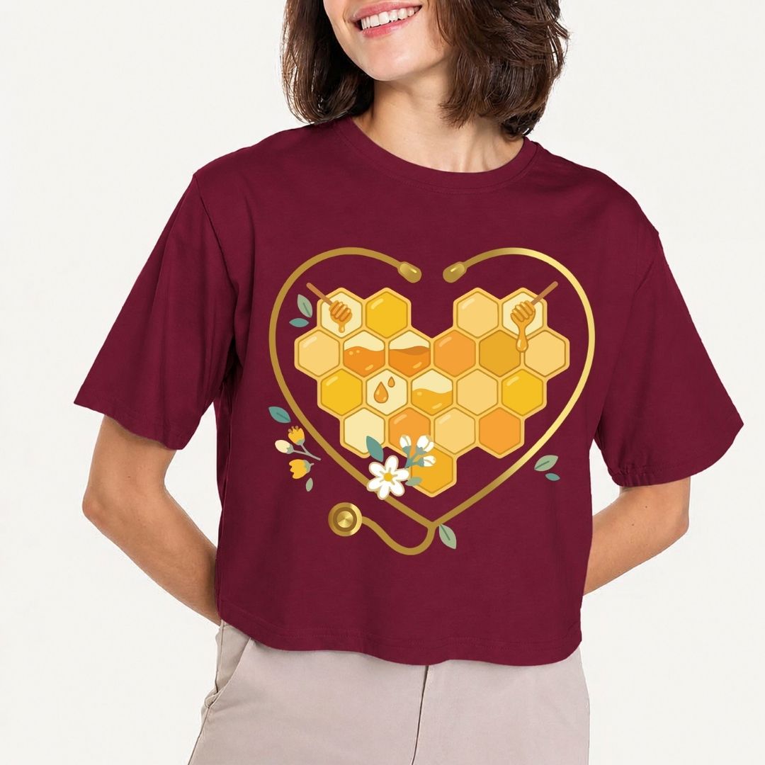 Person wearing a maroon t-shirt with a heart-shaped honeycomb design on a plain background
