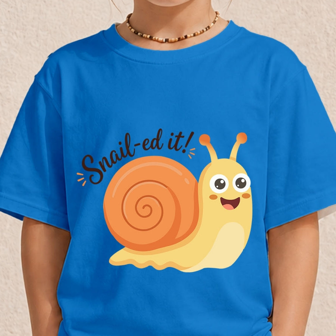 A close-up of a person wearing a bright blue t-shirt featuring a smiling cartoon snail graphic and the text "Snail-ed it!".