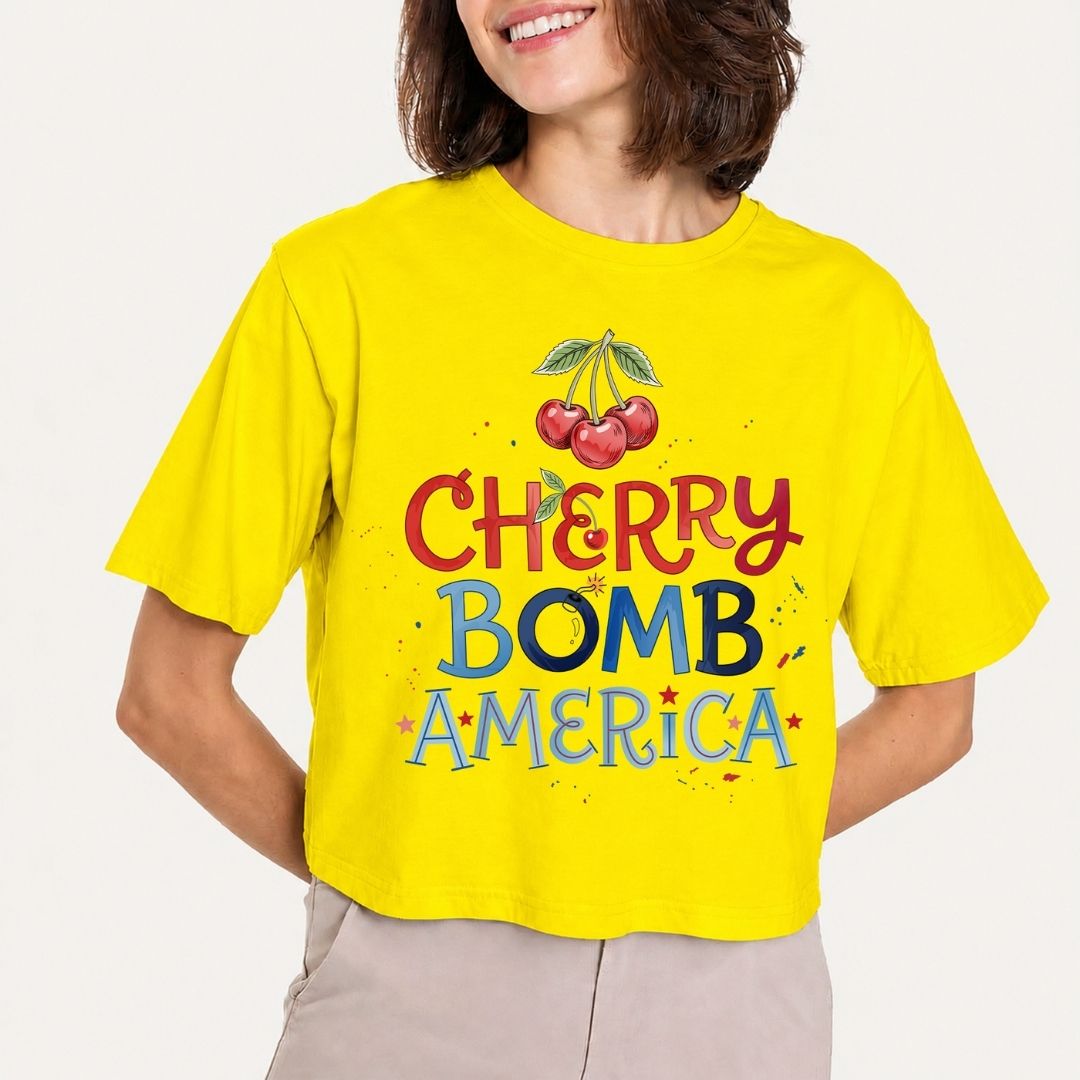 Person wearing a yellow t-shirt with 'Cherry Bomb America' design
