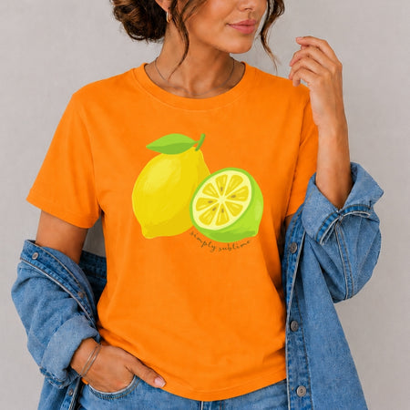 Person wearing an orange t-shirt with lemon graphics and text, standing against a plain background.