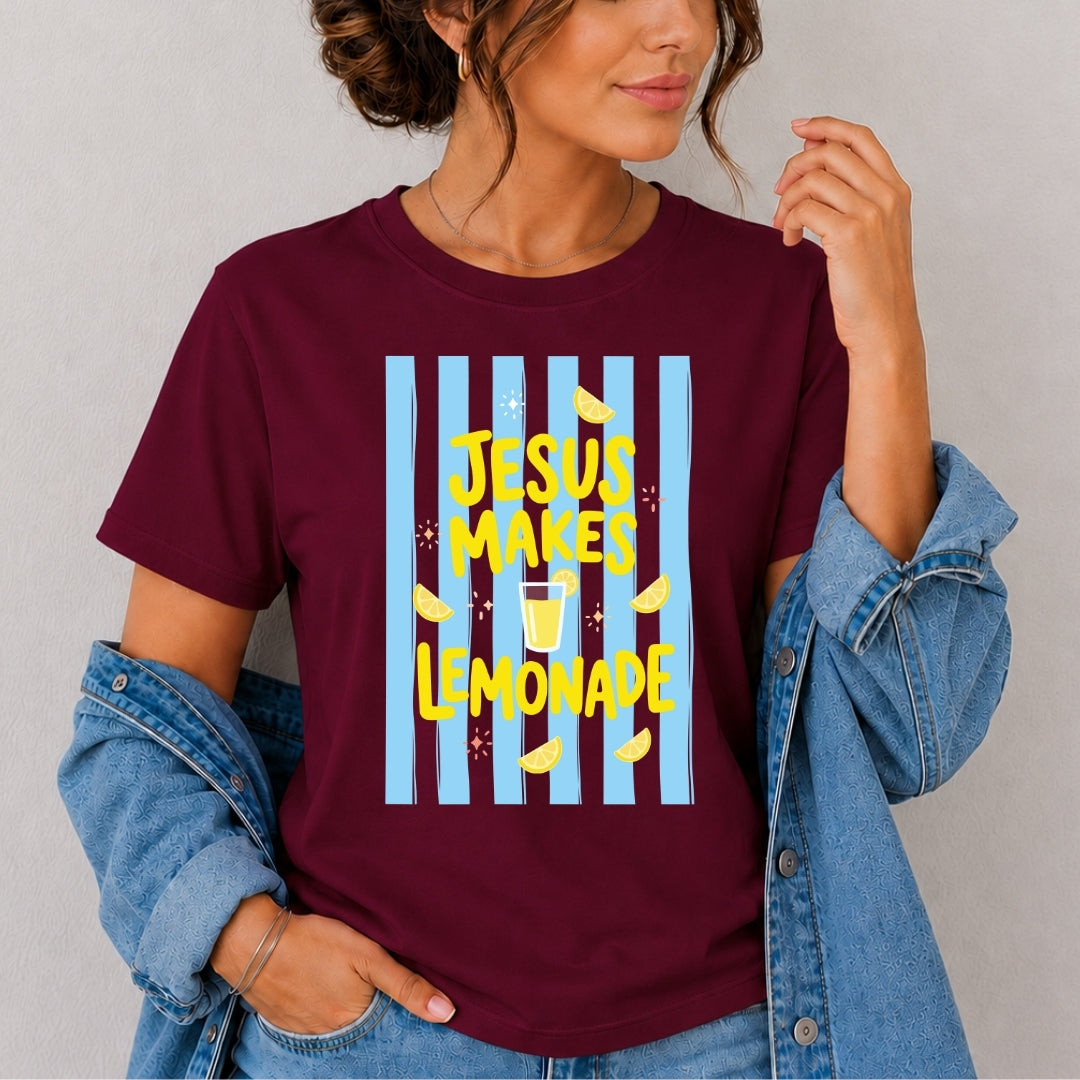 Person wearing a maroon t-shirt with 'Jesus Makes Lemonade' graphic design.