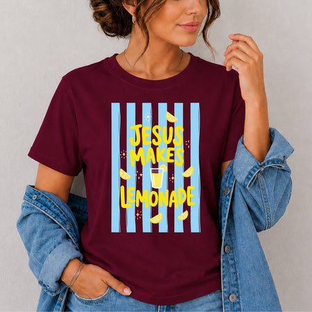 Person wearing a maroon t-shirt with 'Jesus Makes Lemonade' graphic design.