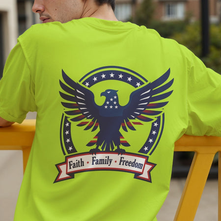 A person seen from the back wearing a neon lime-green t-shirt featuring a patriotic eagle graphic and the text "Faith • Family • Freedom".