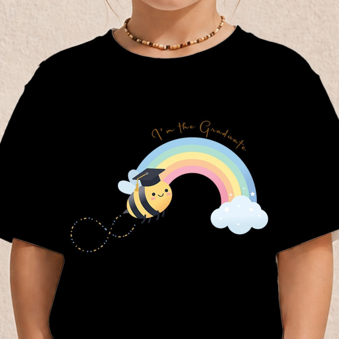 A person wearing a black short-sleeve T-shirt with a colorful cartoon bee and rainbow graphic on the front, plus the text 'I'm the Graduate.' The photo is cropped from the neck to the torso against a light neutral background.