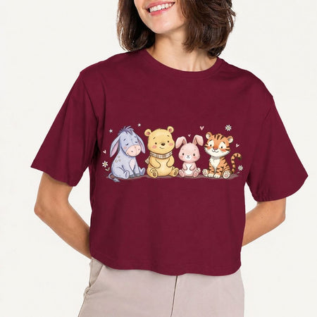 Person wearing a maroon t-shirt with cartoon characters on a plain background