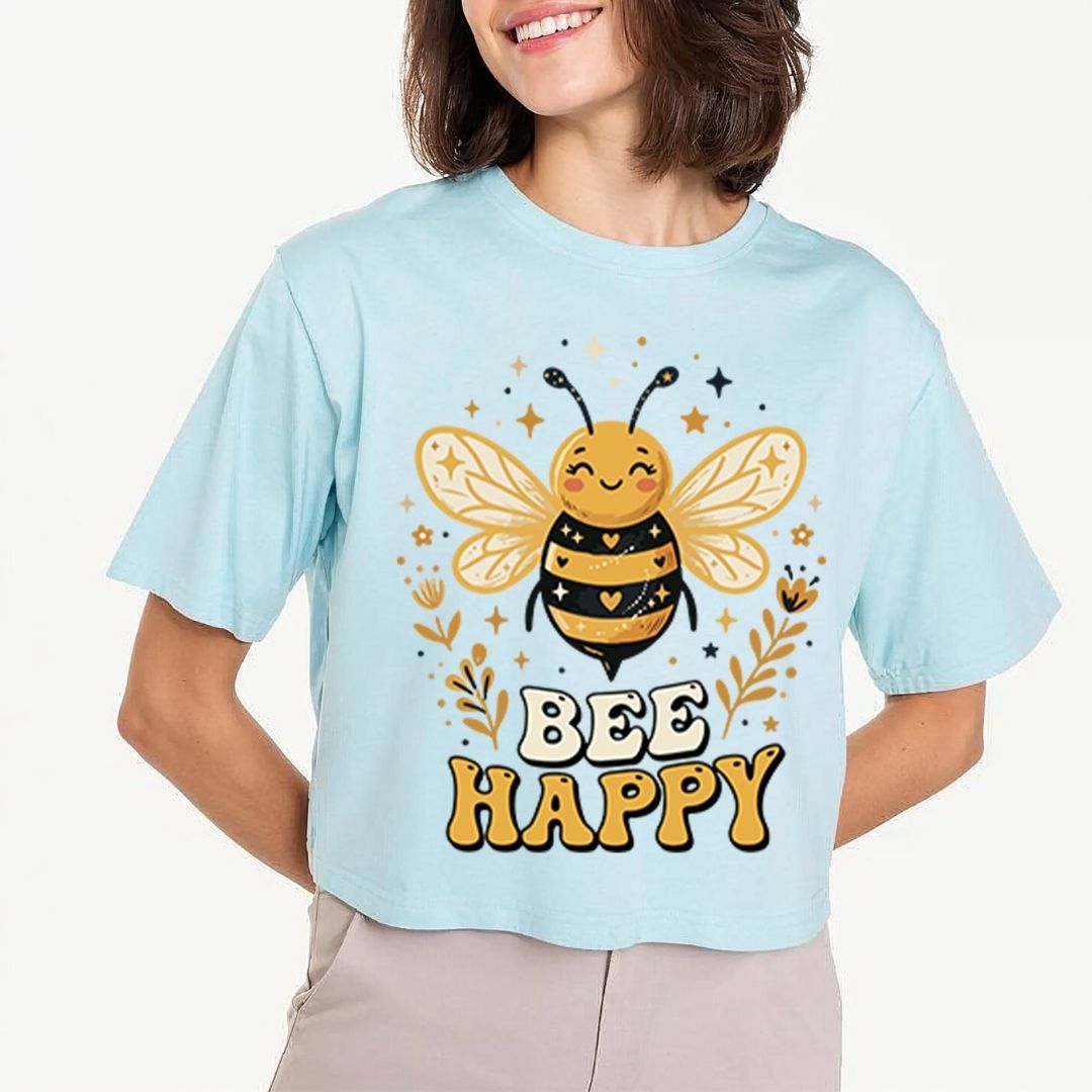 Person wearing a light blue t-shirt with a bee graphic and 'Bee Happy' text.