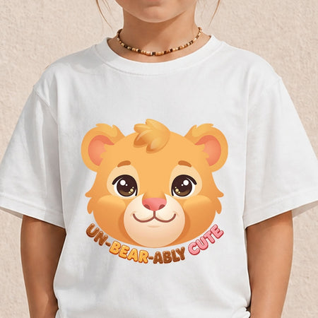 Young child wearing a plain white crewneck t-shirt featuring a cute cartoon bear head illustration and text saying Un-Bear-Ably Cute.