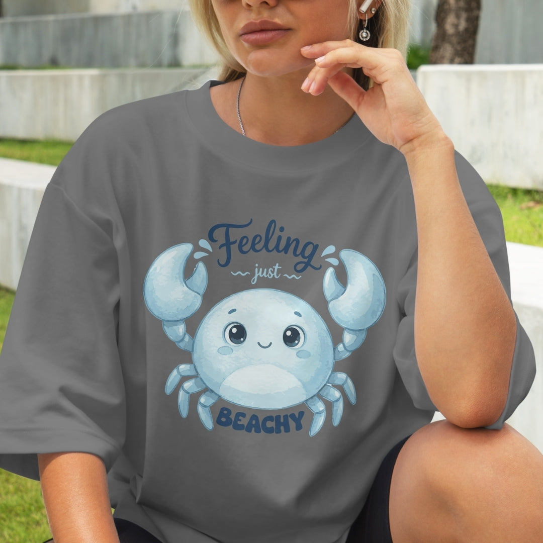Person wearing a gray t-shirt with a blue crab graphic and text.