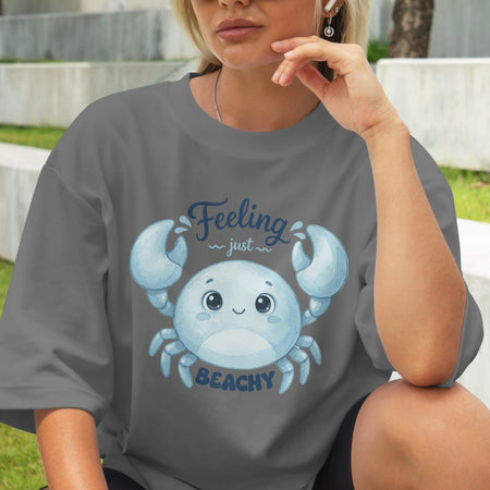 Person wearing a gray t-shirt with a blue crab graphic and text.
