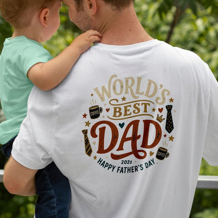 Man wearing a 'World's Best Dad' t-shirt with a child on his shoulders, outdoors.