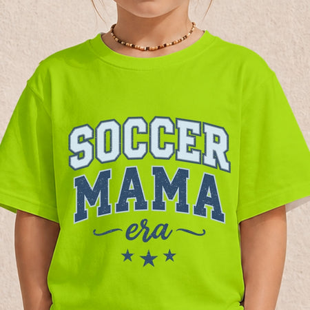 Close-up of a youth or toddler wearing a bright neon green t-shirt printed with a blue varsity-style "Soccer Mama Era" design.