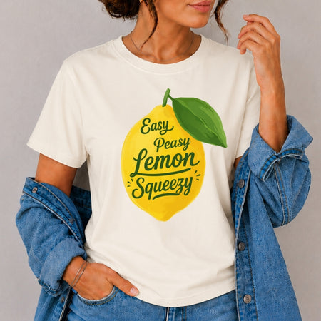 Person wearing a white t-shirt with a lemon graphic and text, standing against a plain background.