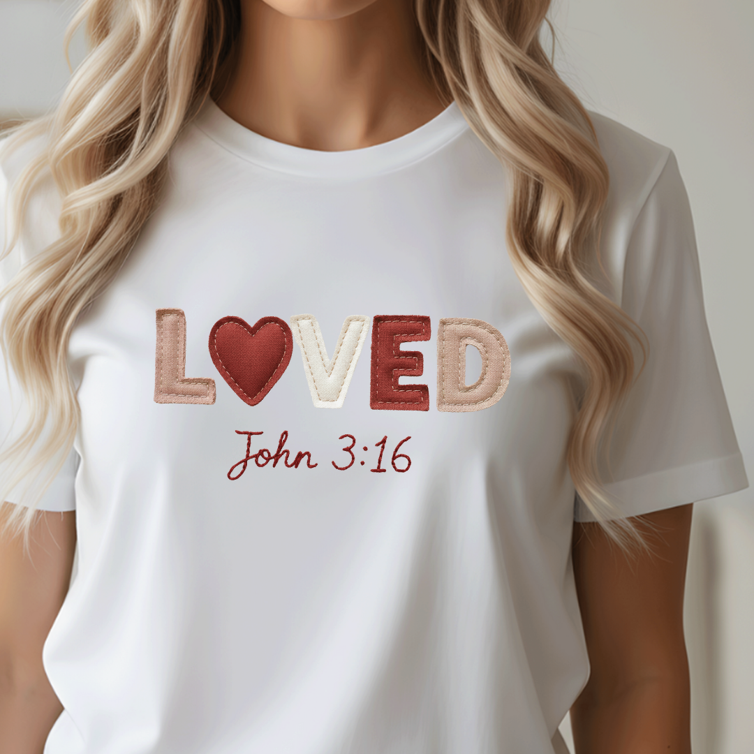 White t-shirt with 'LOVED John 3:16' text and heart design on a plain background