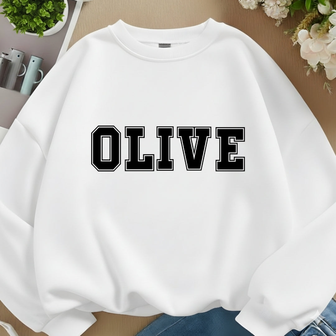White sweatshirt with 'OLIVE' printed on it, placed on a surface with a neutral background.