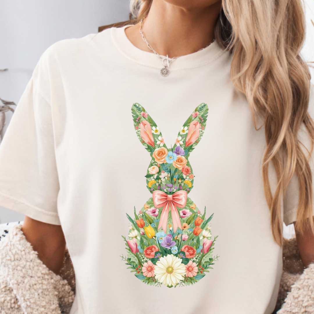 White t-shirt with a floral bunny design worn by a person.