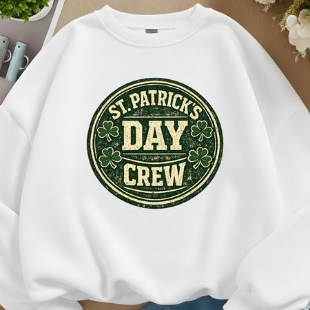 White sweatshirt with 'St. Patrick's Day Crew' text and shamrock design on a neutral background