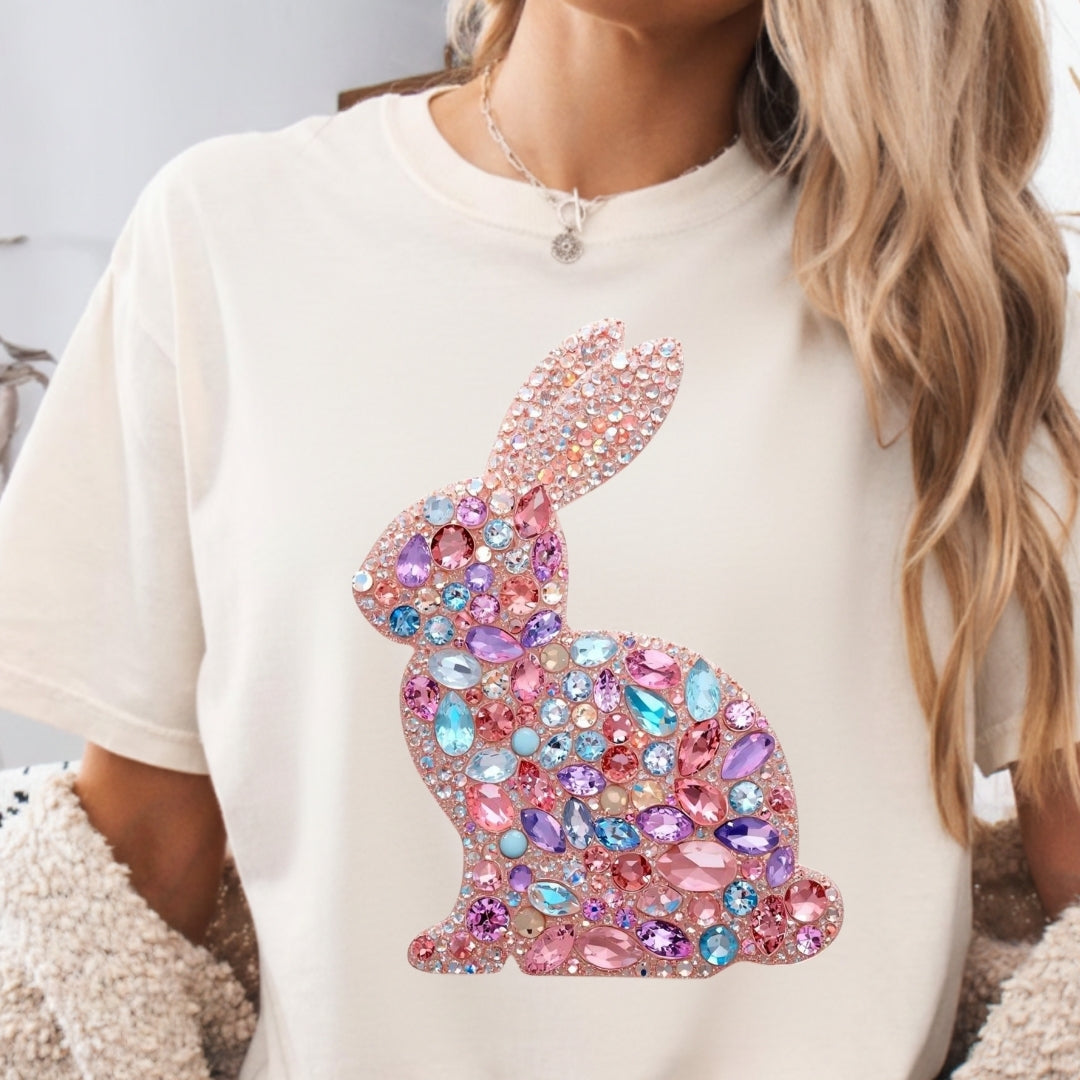 White t-shirt with a colorful bunny design worn by a person.