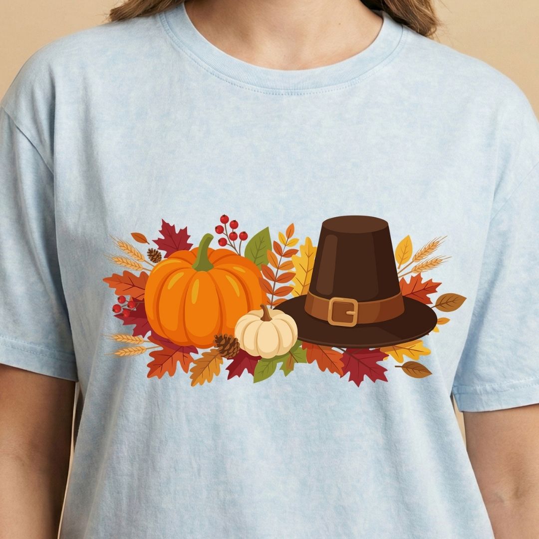 Light blue t-shirt with a Thanksgiving design featuring pumpkins and a pilgrim hat.