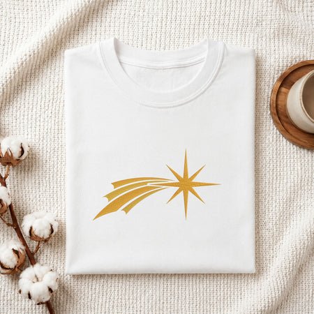Folded white cotton t-shirt mockup featuring a golden comet star machine embroidery design, styled with cotton stems and a wooden cup