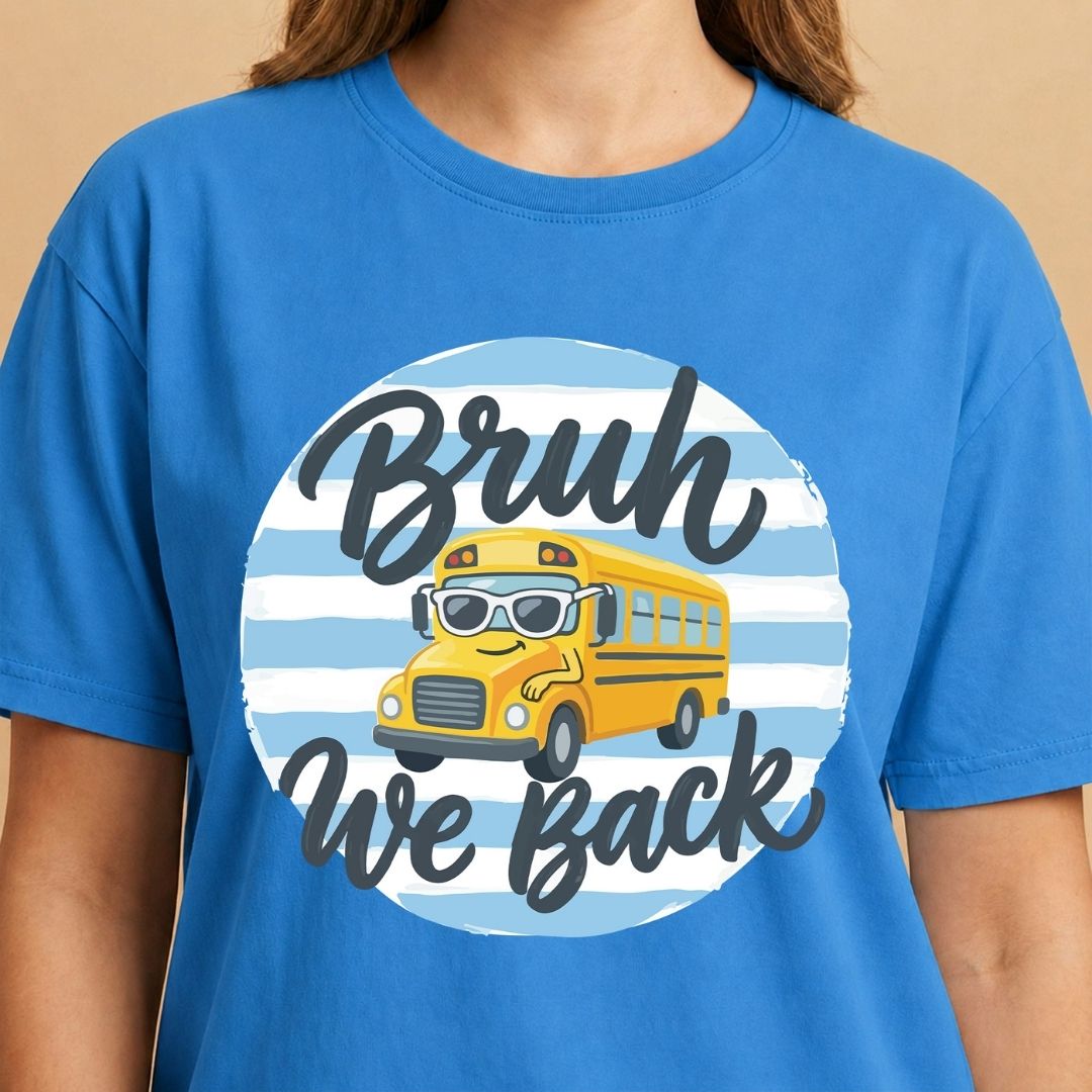 Blue t-shirt with a yellow school bus graphic and text on a beige background