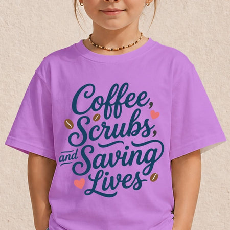 A child wearing a lavender purple t-shirt with the text 'Coffee, Scrubs, and Saving Lives' in dark blue script, decorated with small coffee beans and pink hearts, against a textured beige wall.