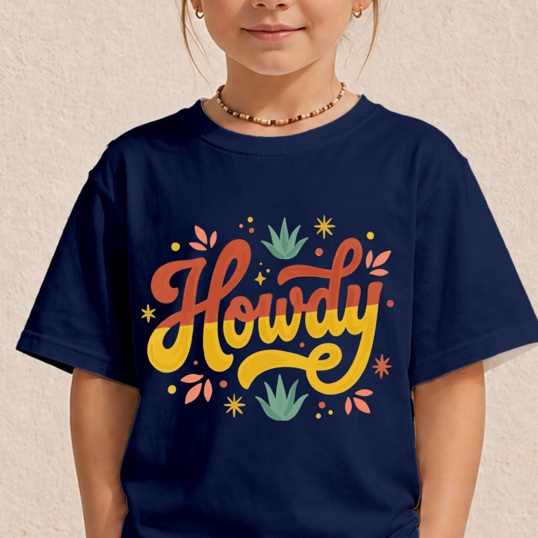 A young child wearing a deep navy blue t-shirt displaying a colorful, vintage style "Howdy" script graphic on the front.