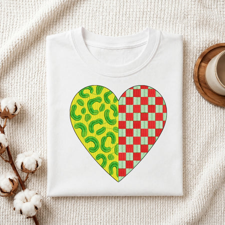 A neatly folded white t-shirt featuring a heart-shaped embroidery design with a split leopard print and red checkered pattern.