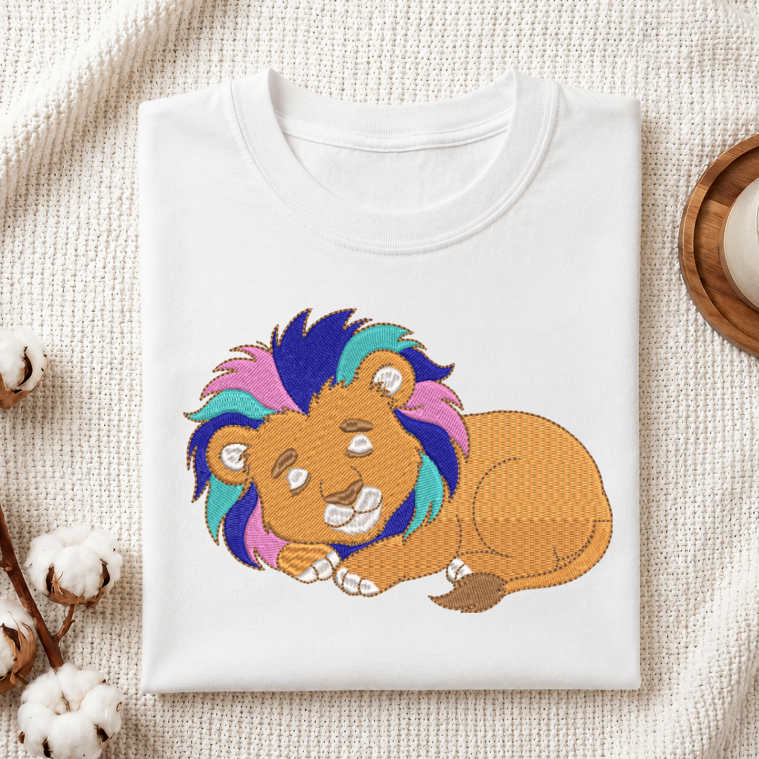 White t-shirt with a colorful lion design on a textured surface