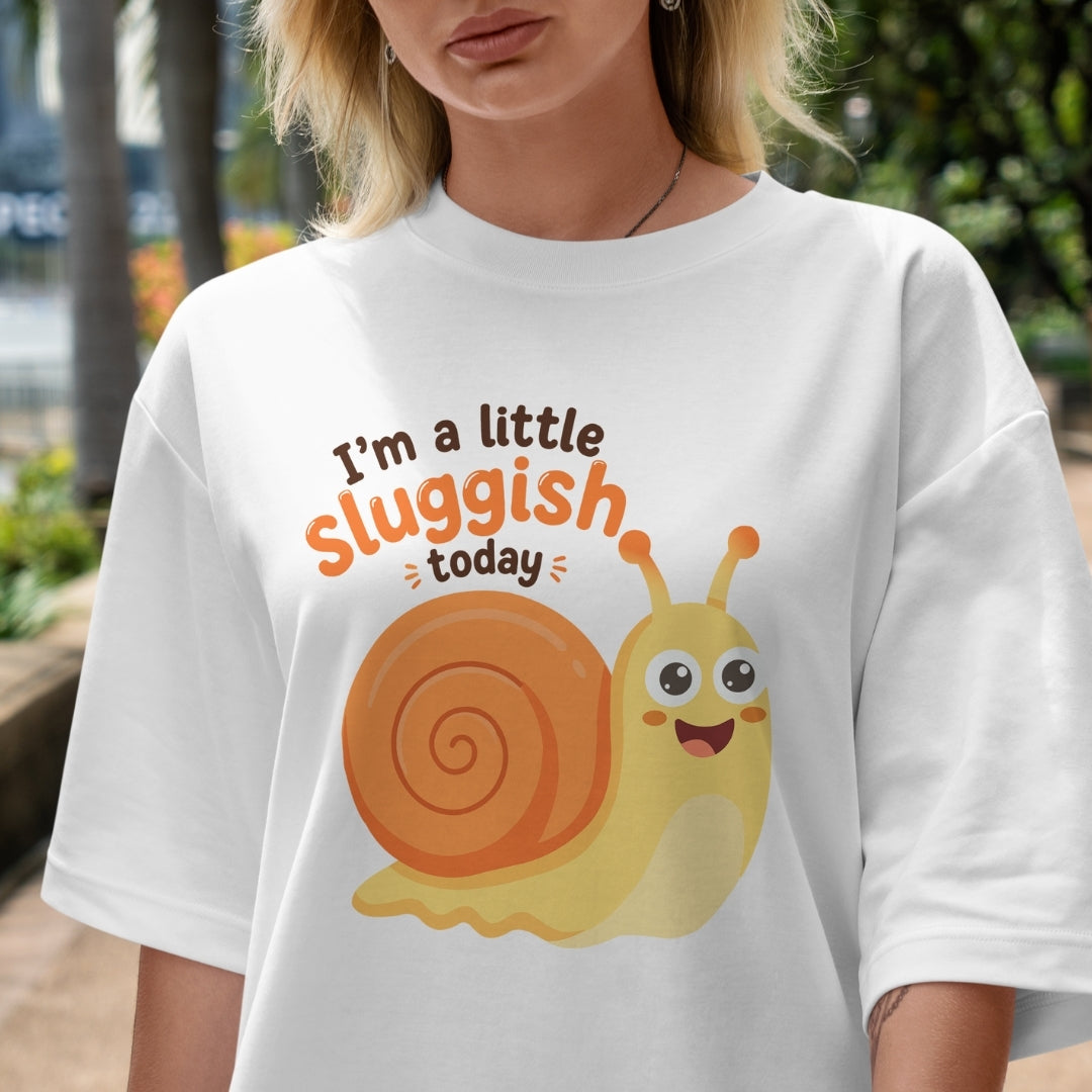 Person wearing a white t-shirt with a cartoon snail and text 'I'm a little sluggish today'.