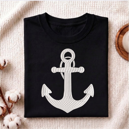 Black t-shirt with a white anchor design on a textured surface.