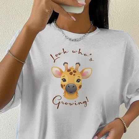 Person wearing a white t-shirt with a giraffe graphic and text.