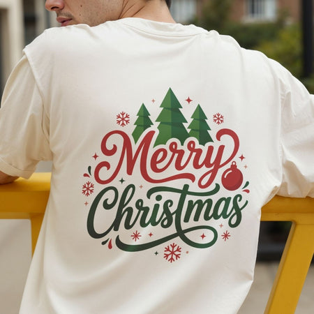 Back view of a person wearing an off-white t-shirt featuring a colorful "Merry Christmas" lettering and winter tree design.