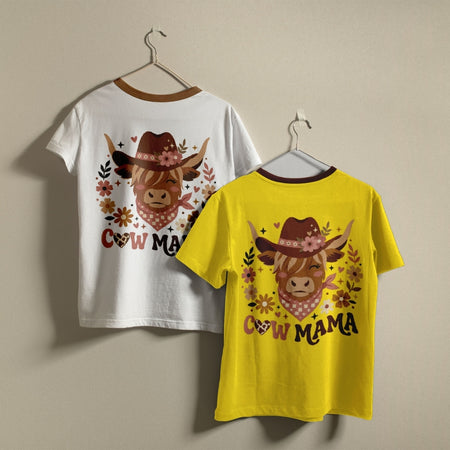 Two short-sleeve ringer T-shirts hanging on hangers against a plain beige wall. The left shirt is white with a brown collar and features a cowgirl cow graphic with the text 'COW MAMA' in brown.