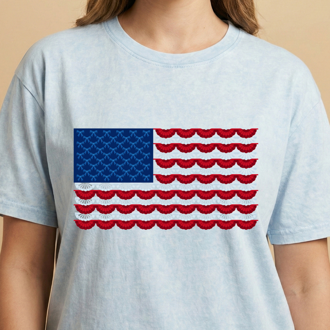 Light blue t-shirt with a red, white, and blue flag design on a beige background