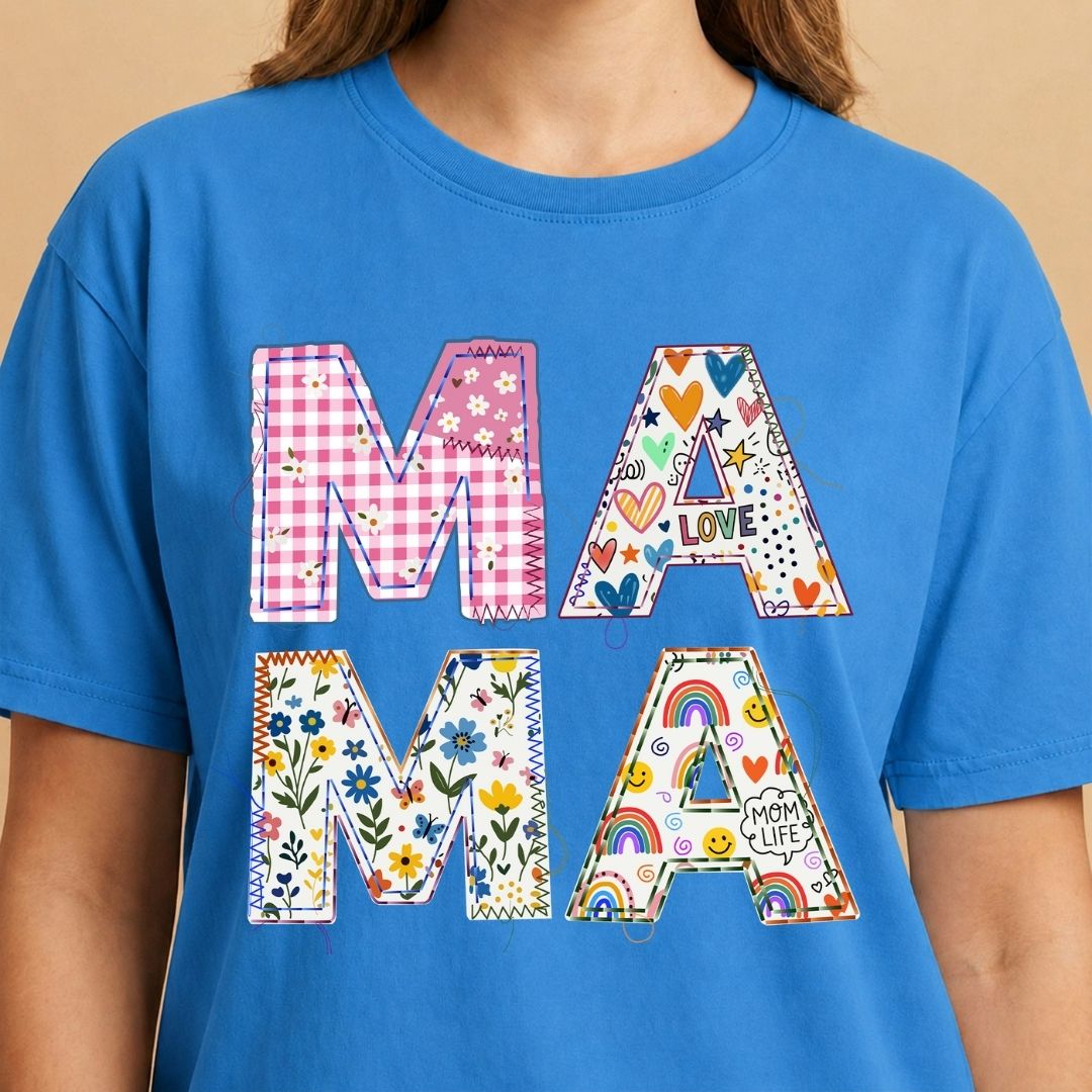 Blue t-shirt with colorful 'MAMA' text design on a beige background