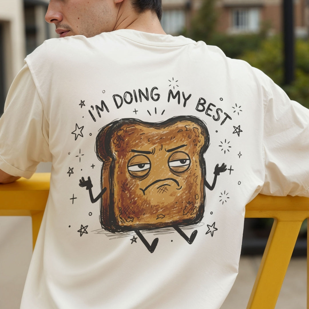 Back view of a person wearing a cream-colored t-shirt showcasing the funny grumpy burnt toast character design.