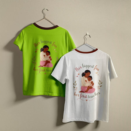 Two crewneck t-shirts, one white and one bright green, hanging against a wall displaying the mother-daughter Mother's Day graphic print design.