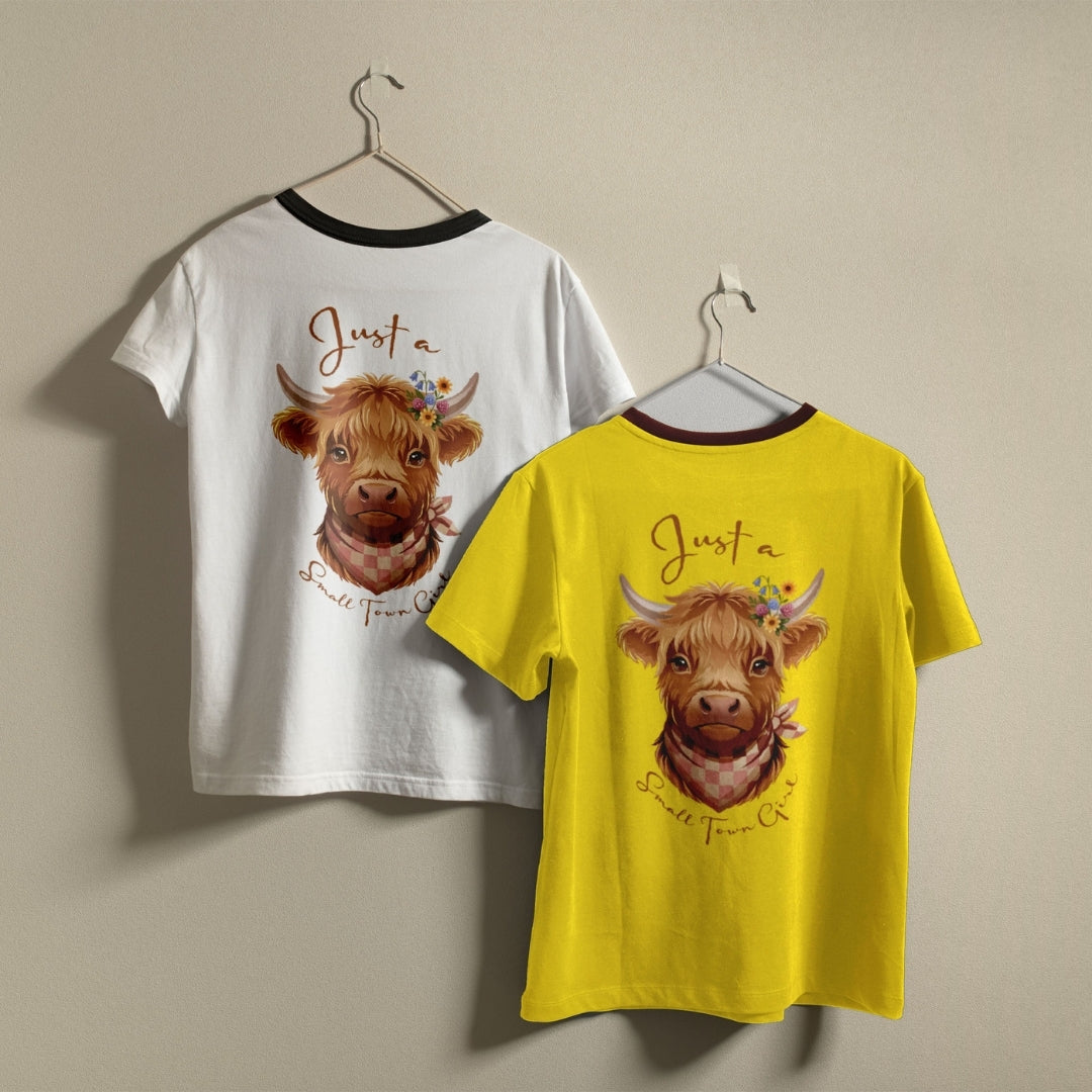Two children's ringer t-shirts hanging on hangers against a plain beige wall. One shirt is white with a black collar trim, and the other is bright yellow with a dark red collar trim.