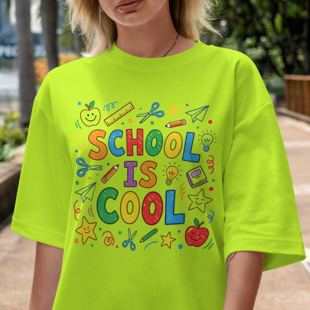 Person wearing a bright green t-shirt with 'School is Cool' text and graphics.