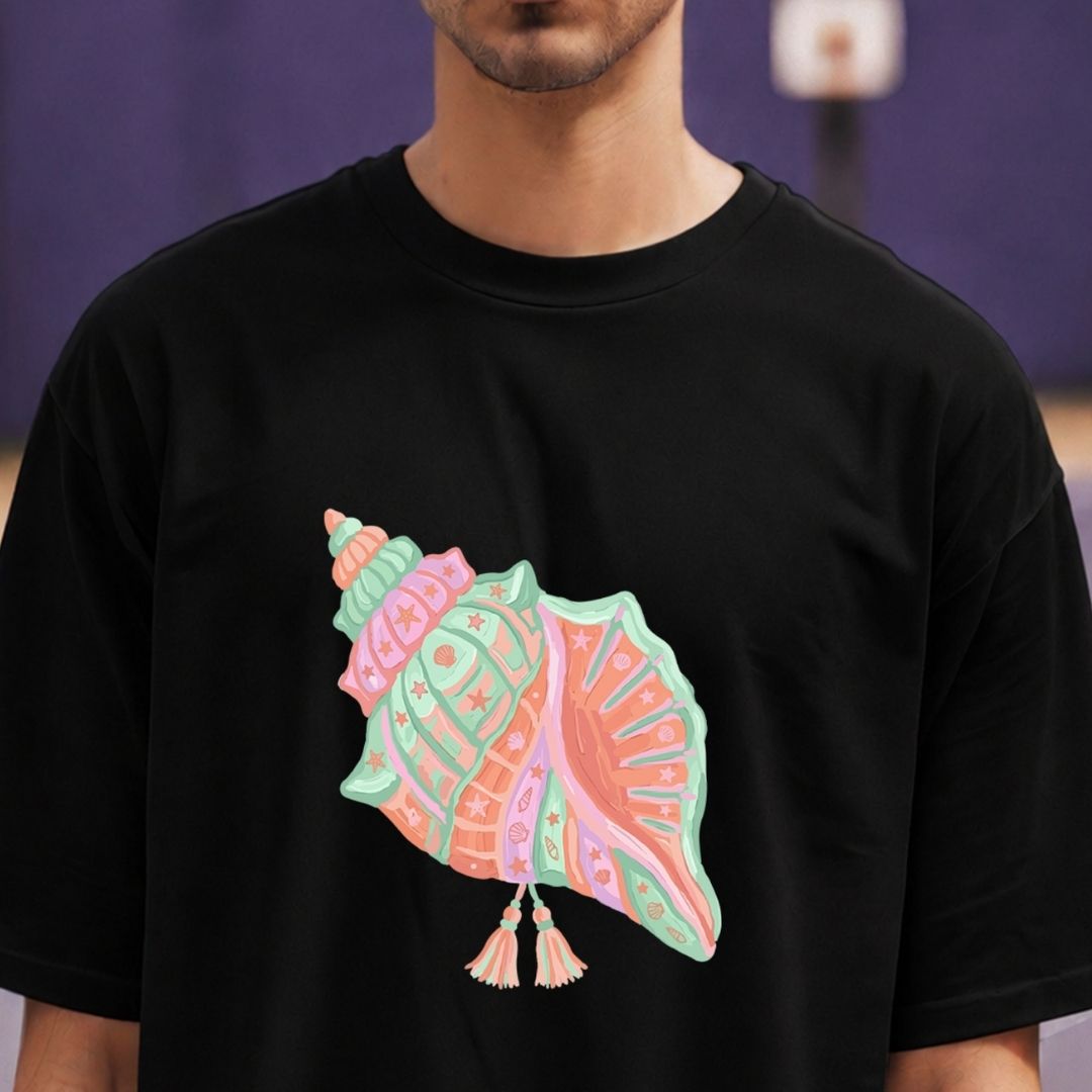 Person wearing a black t-shirt with a colorful shell design on a blurred background