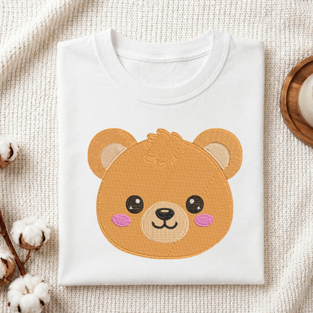 White t-shirt with a bear face design on a textured beige surface.