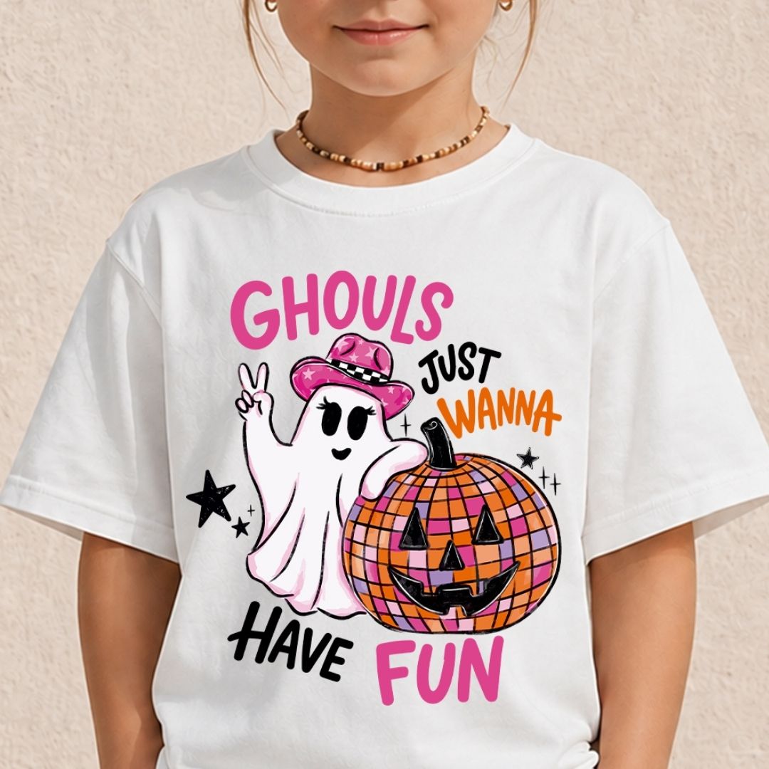 A child wearing a white crewneck t-shirt showcasing the Ghouls Just Wanna Have Fun pink and orange Halloween graphic.