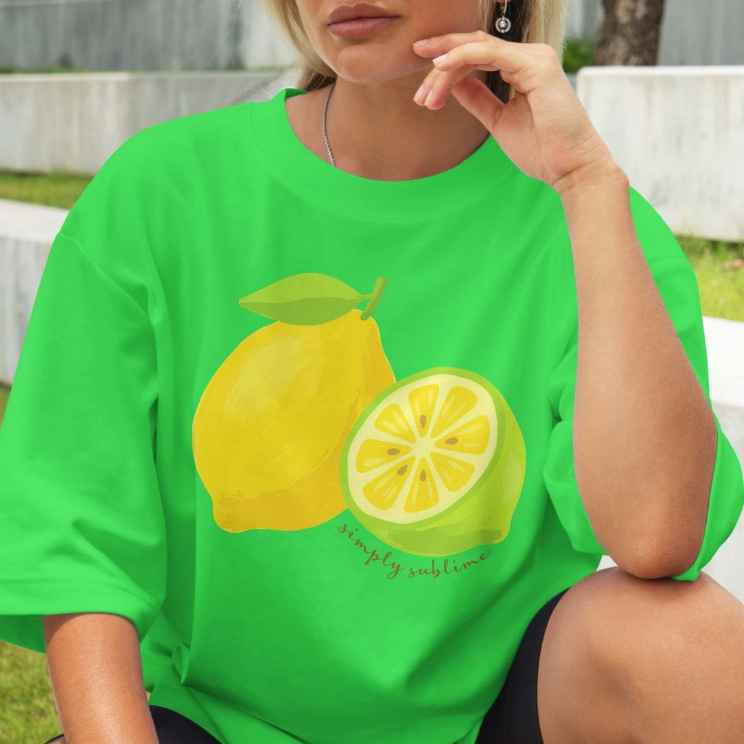 Person wearing a green t-shirt with lemon graphics and text.
