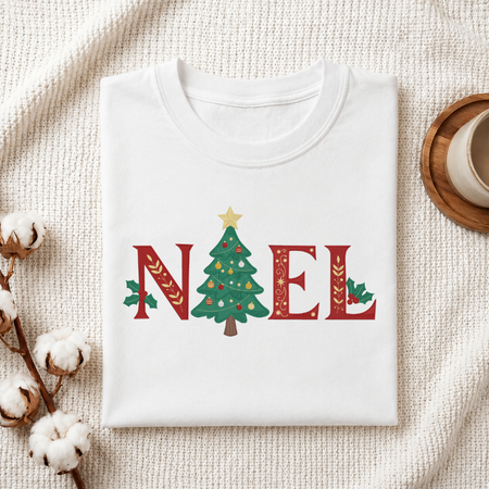  Folded white cotton t-shirt mockup featuring a "NOEL" Christmas tree machine embroidery design, styled with cotton stems and a wooden cup   