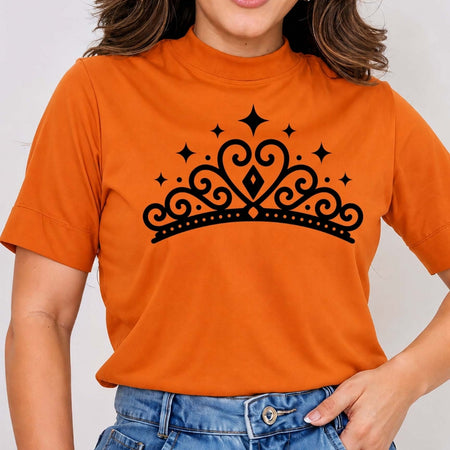 Person wearing an orange t-shirt with a black tiara design on a plain background