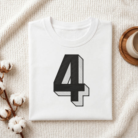 A neatly folded white crewneck t-shirt featuring a stitched 3D block number "4" design, styled with cotton branches and a wooden coaster.