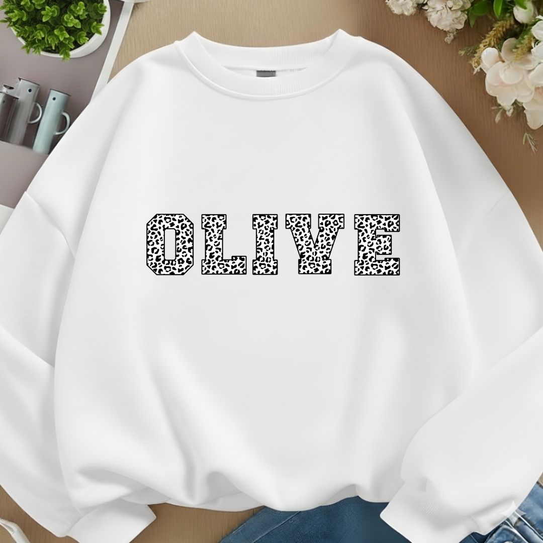 White sweatshirt with 'OLIVE' printed in leopard print on a neutral background