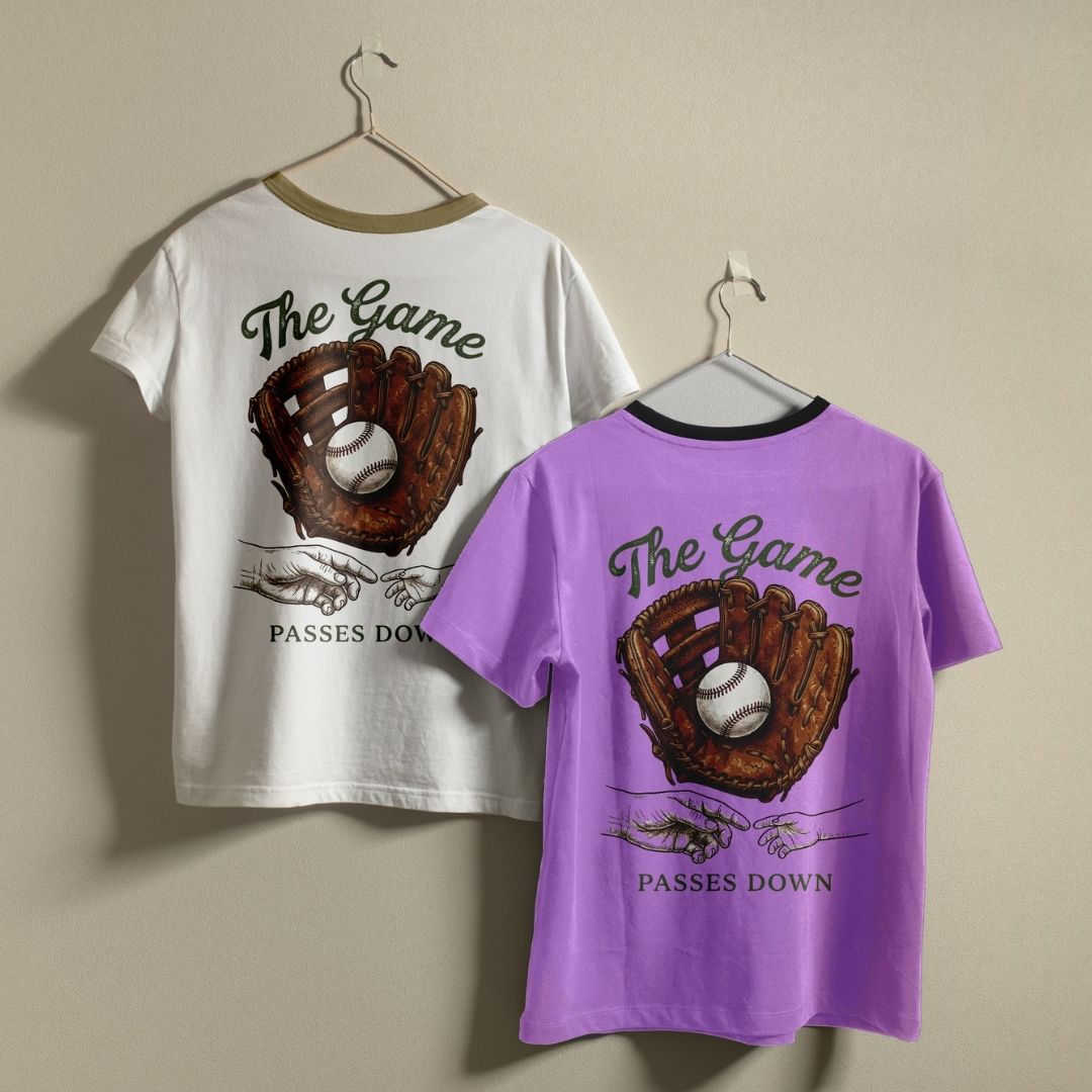 Baseball Passes Down Graphic T-Shirts on Hangers in White and Purple