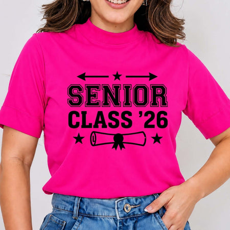 Person wearing a pink t-shirt with 'Senior Class '26' text on a plain background